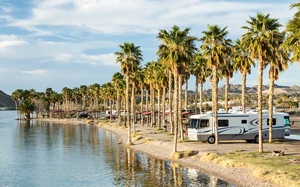 A motorhome parked at a RV camp by the water