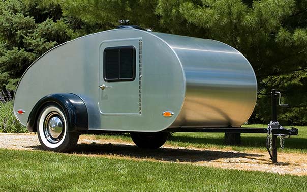 A silver tear drop style retro travel trailer